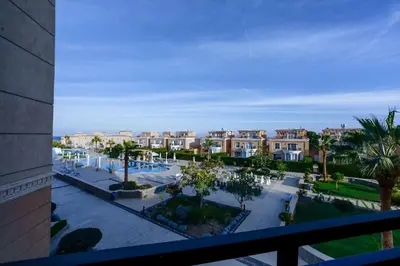 a view of a city with palm trees and buildings at Arena Beach Resort - Premium Suites in Hurghada