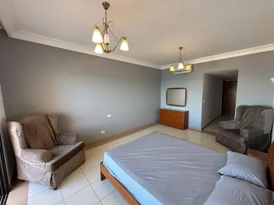 a bedroom with a bed and a couch and a chair at Panoramic Sea View in Hurghada