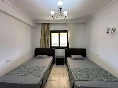 a bedroom with two beds and a window at Panoramic Sea View in Hurghada