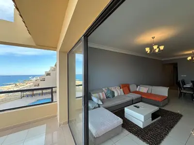 a living room with a couch and a view of the ocean at Panoramic Sea View in Hurghada