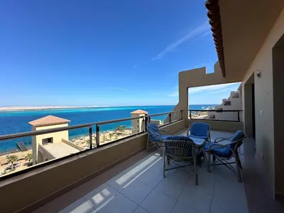 a balcony with chairs and a view of the ocean at Panoramic Sea View in Hurghada