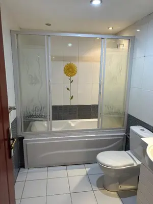 a bathroom with a toilet and a yellow flower on the wall at Panoramic Sea View in Hurghada