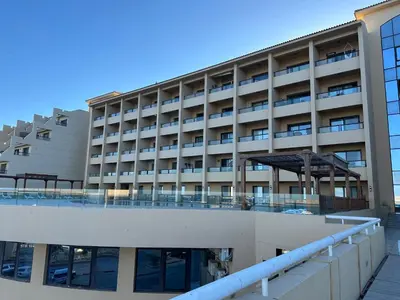 an apartment building with a walkway in front of it at Panoramic Sea View in Hurghada