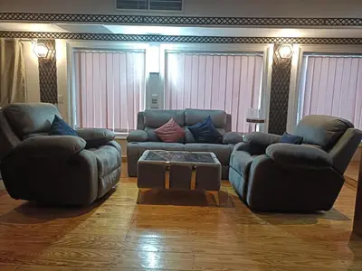 a living room with two couches and a coffee table at FayedBasmadahabiya in Luxor