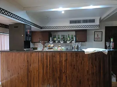 a kitchen with a bar with bottles on the wall at FayedBasmadahabiya in Luxor