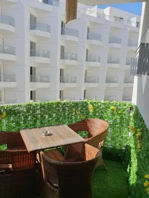 a patio with a table and chairs and a building at luxury apartment with sea view in Hurghada
