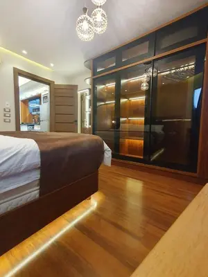 a bedroom with a bed and a chandelier at luxury apartment with sea view in Hurghada