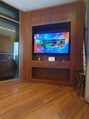 a living room with a flat screen tv on a wall at luxury apartment with sea view in Hurghada