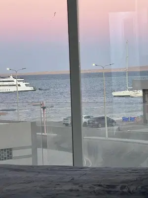 a view of the ocean from a room with a window at Маленький голубий кит in Hurghada