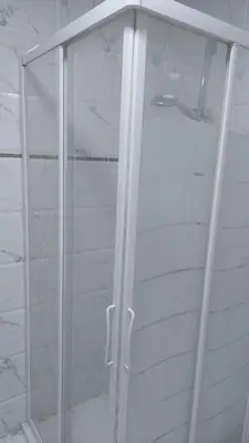 a shower with a glass door in a bathroom at Маленький голубий кит in Hurghada