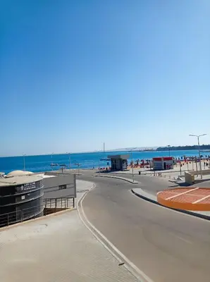 a view of a beach with people on the beach at Маленький голубий кит in Hurghada