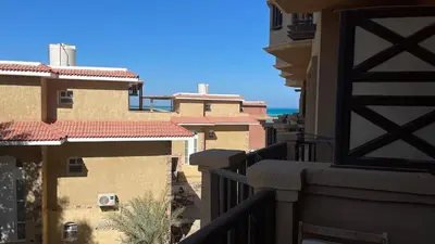 a view from a balcony of buildings and the ocean at Studio in turtels beach in Hurghada