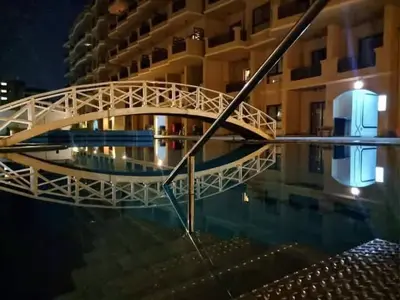 a bridge over a pool of water in front of a building at Studio in turtels beach in Hurghada