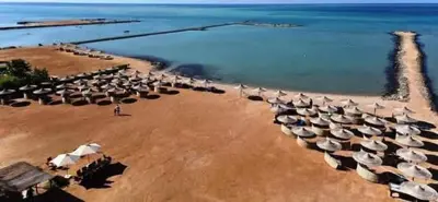 a group of umbrellas on a beach near the water at Studio in turtels beach in Hurghada