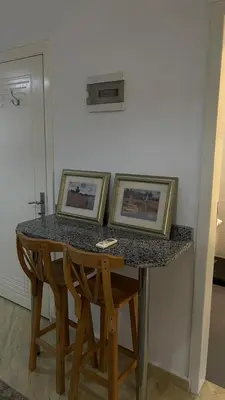 two framed pictures on a table with two chairs at Studio in turtels beach in Hurghada
