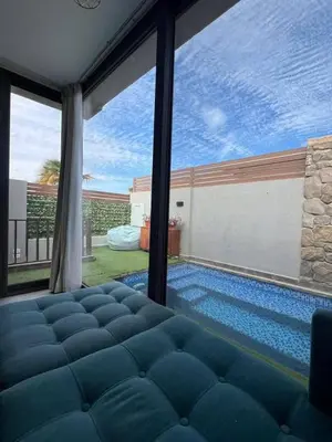 a bedroom with a swimming pool and a large window at One Bedroom Apartment in El Gouna Bali in Hurghada