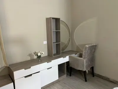 a dressing table with a mirror and a chair at One Bedroom Apartment in El Gouna Bali in Hurghada