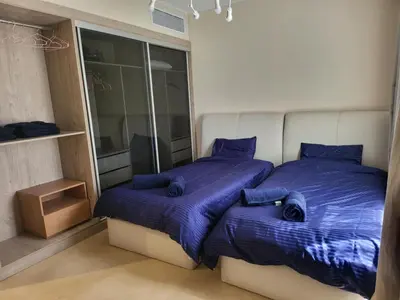 a bedroom with two beds with blue sheets and a window at ELgouna Mangroovy stylish 4 bedroom in Hurghada