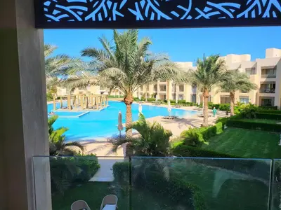 a view of the pool from the balcony of a resort at ELgouna Mangroovy stylish 4 bedroom in Hurghada