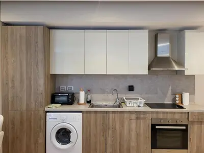 a kitchen with a sink and a washing machine at ELgouna Mangroovy stylish 4 bedroom in Hurghada