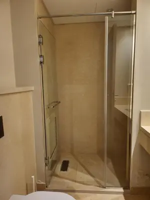 a shower with a glass door in a bathroom at ELgouna Mangroovy stylish 4 bedroom in Hurghada