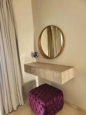a mirror and a purple ottoman in a room at ELgouna Mangroovy stylish 4 bedroom in Hurghada