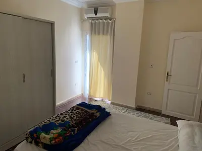 a bedroom with a large bed with a window at Downtown Studio in Hurghada