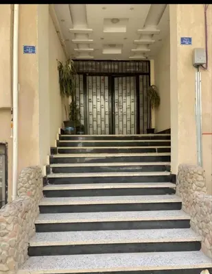 a set of stairs in front of a building with a door at Downtown Studio in Hurghada