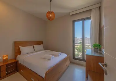 a bedroom with a bed and a large window at Beautiful 4BR Villa in Tawila El Gouna Private Pool & Lagoon Access in Hurghada