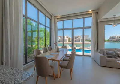 a dining room with a table and chairs at Beautiful 4BR Villa in Tawila El Gouna Private Pool & Lagoon Access in Hurghada