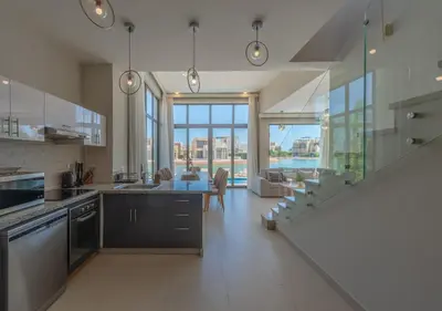 a large kitchen with a view of a living room at Beautiful 4BR Villa in Tawila El Gouna Private Pool & Lagoon Access in Hurghada
