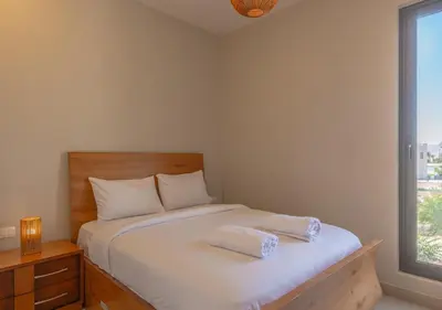 a bedroom with a white bed with a window at Beautiful 4BR Villa in Tawila El Gouna Private Pool & Lagoon Access in Hurghada
