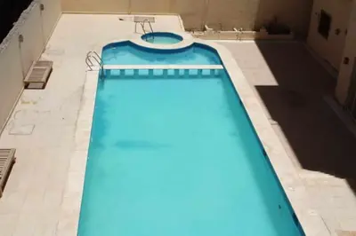 a swimming pool with blue water in a building at Magyipt in Hurghada