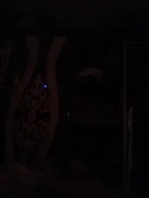 a dark room with a clock in the dark at السقالة ميدان اكا in Hurghada