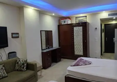 a room with a bed and a couch and a tv at Luxury Cecelia resort in Hurghada