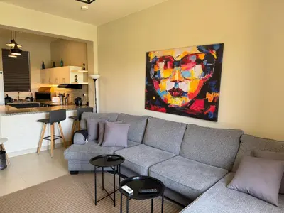 a living room with a couch and a painting on the wall at NEXT STAY, Lagoon Townhouse, El Gouna in Hurghada