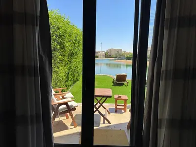 a window view of a patio with a view of a lake at NEXT STAY, Lagoon Townhouse, El Gouna in Hurghada