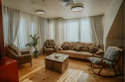 a living room with a couch and chairs and a table at Azhar Dahabiya luxury suites in Esna