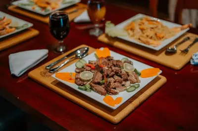 a plate of food on a wooden table at Azhar Dahabiya luxury suites in Esna
