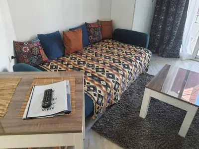 a living room with a bed and a table at Flat in Hughada Aqua Palms 52 M2 in Hurghada