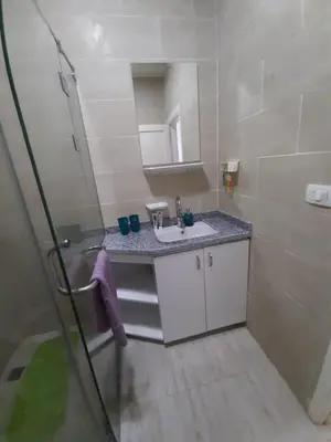 a bathroom with a sink and a mirror at Flat in Hughada Aqua Palms 52 M2 in Hurghada