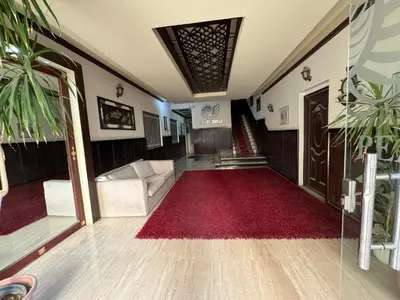 a living room with a red carpet and a staircase at Blue Pearl 203 1BR in Hurghada