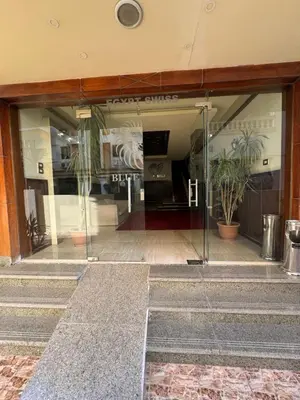 an entrance to a building with glass doors and potted plants at Blue Pearl 203 1BR in Hurghada