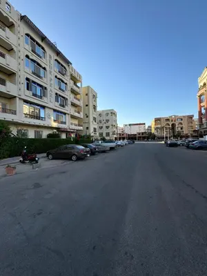 an empty street with cars parked in front of buildings at Blue Pearl 203 1BR in Hurghada