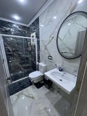 a bathroom with a sink and a toilet and a mirror at Blue Pearl 203 1BR in Hurghada