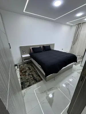 a bedroom with a bed in a room with marble floors at Blue Pearl 203 1BR in Hurghada