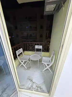 a view of a balcony with chairs and a table at Blue Pearl 203 1BR in Hurghada