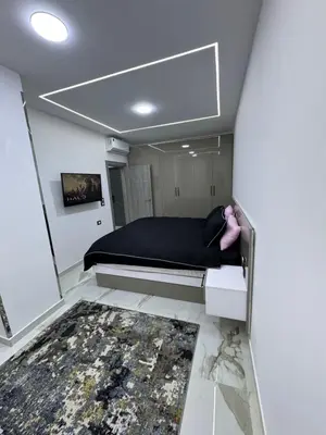 a small bedroom with a bed and a rug at Blue Pearl 203 1BR in Hurghada