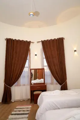 a bedroom with two beds and a mirror at Golden Land in ‘Ezbet Abu Ḥabashi