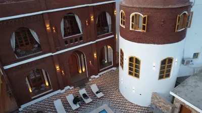 an aerial view of a building with chairs in the courtyard at Golden Land in ‘Ezbet Abu Ḥabashi